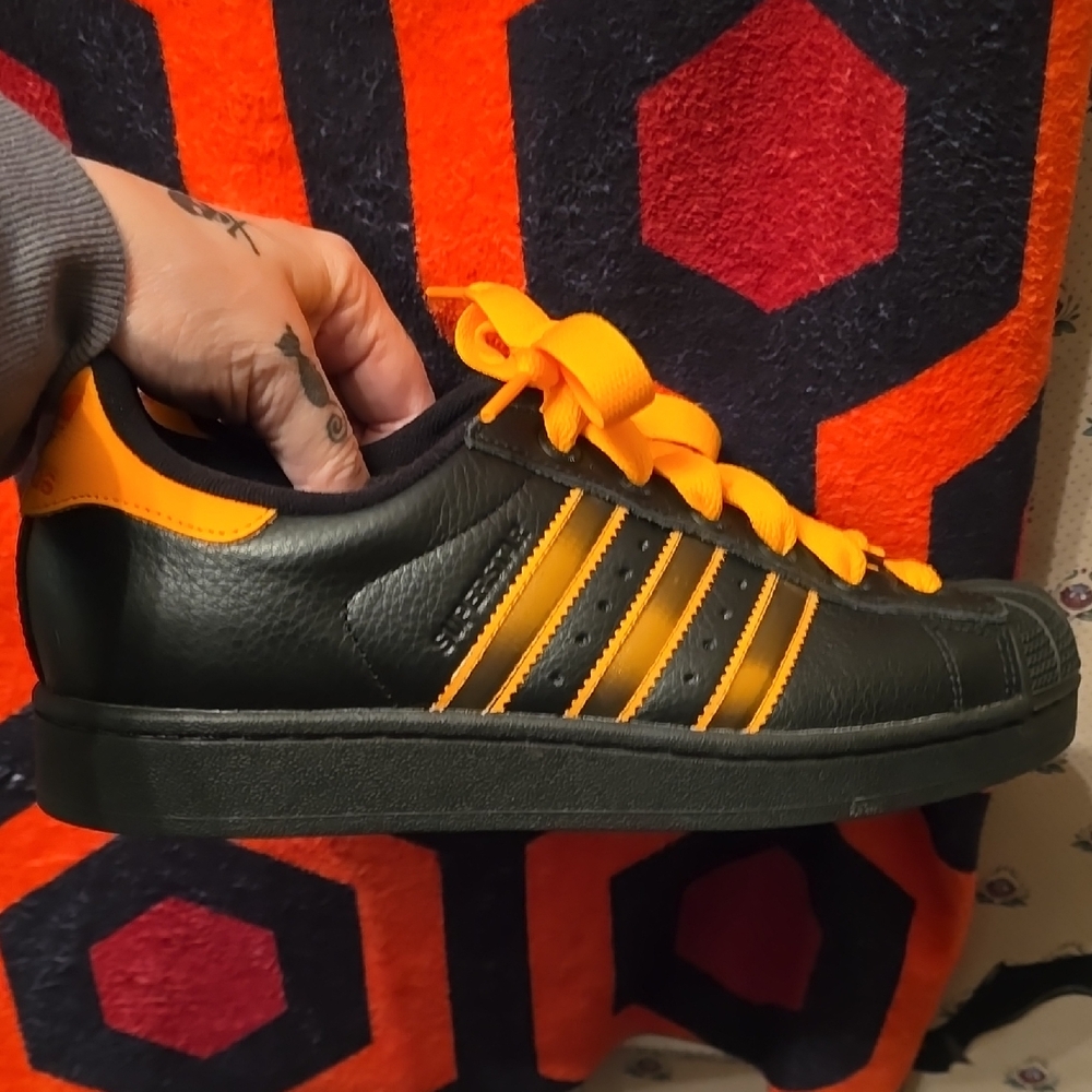 Adidas Superstar II shoe in Core Black, Crew Orange, and Semi Impact Orange.